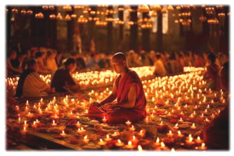 monk-sits-front-large-crowd-candles